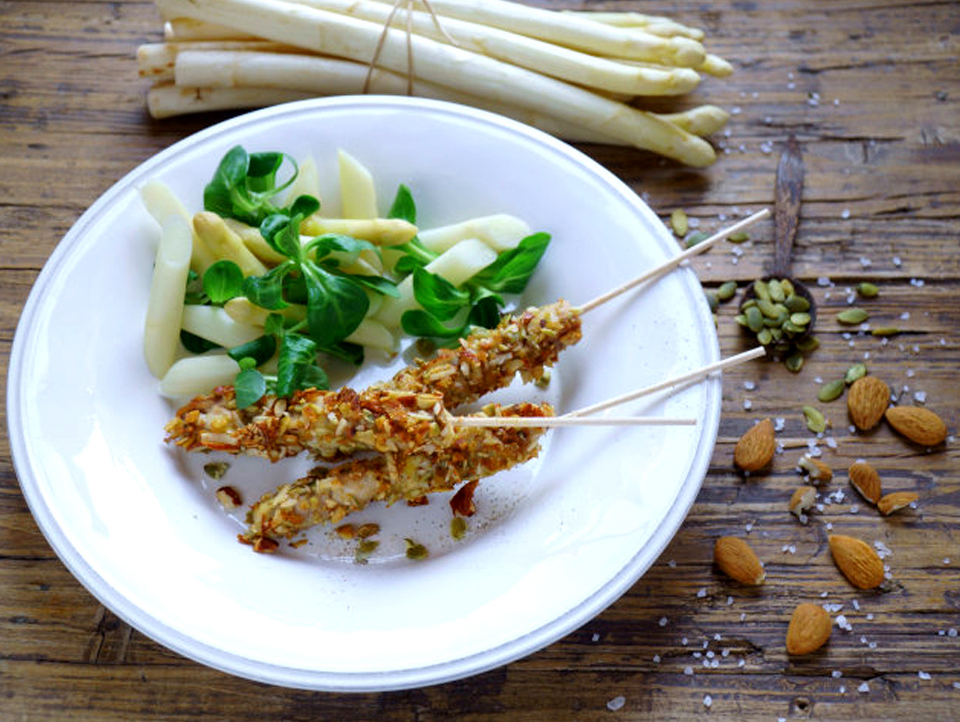 Arrosticini con semi di zucca, mandorle e asparagi bianchi