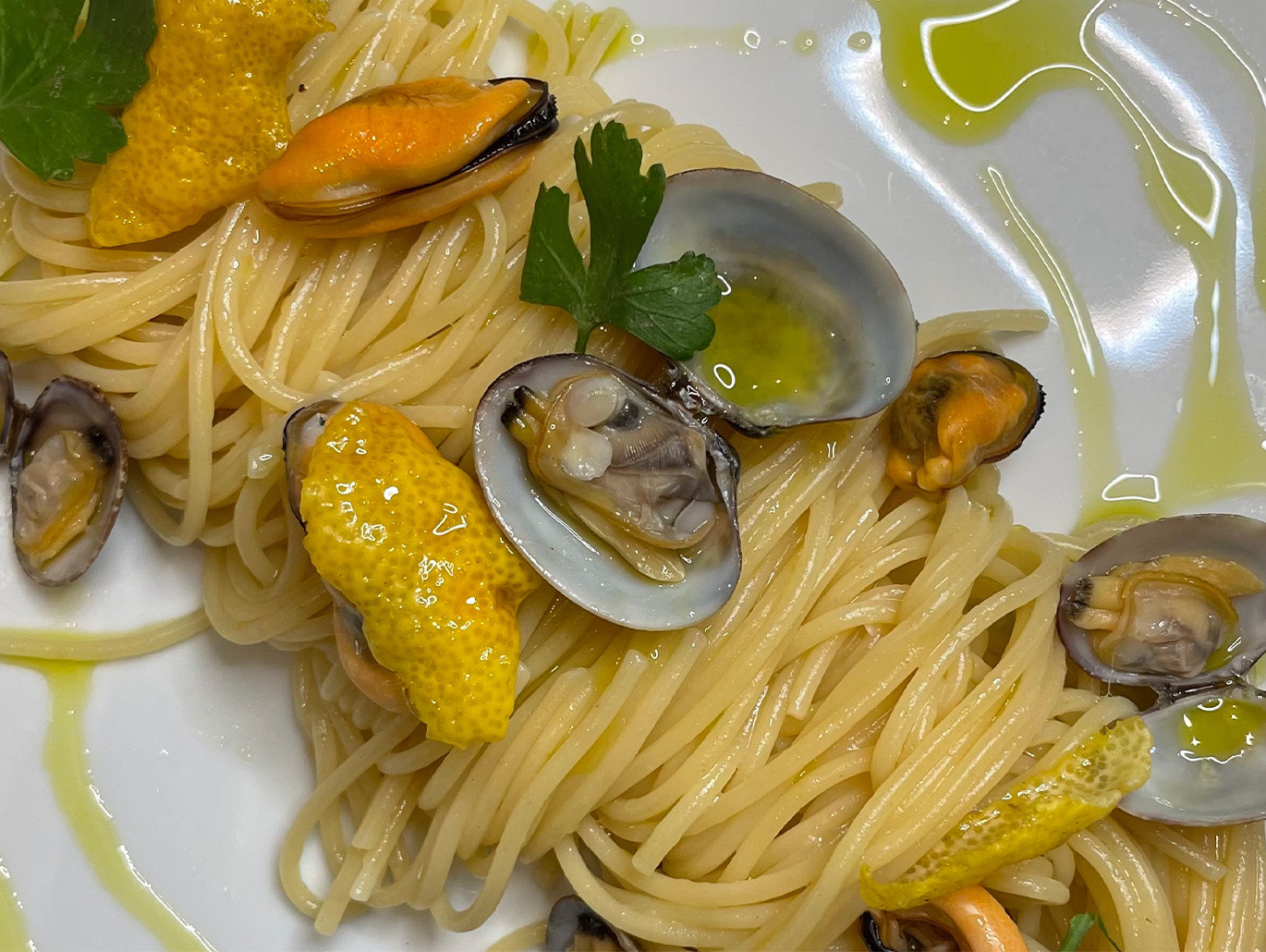 Spaghetti alla chitarra con cozze e vongole, olio al prezzemolo e limone candito